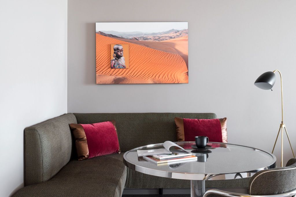 Corner couch and small dining table in a hotel room breakfast nook